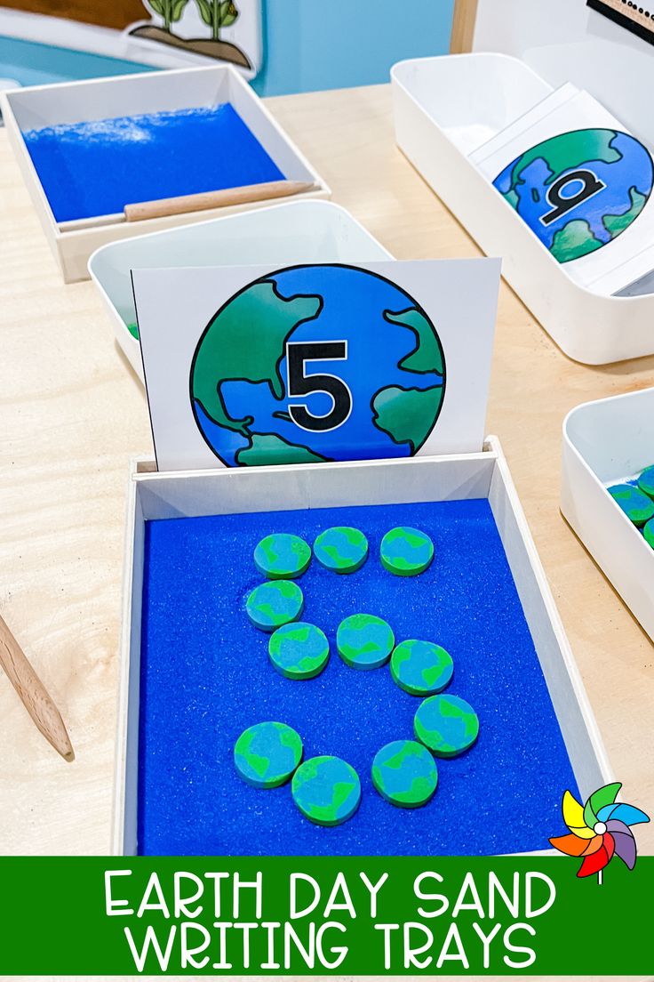 the earth day sand writing trays are ready for students to write and practice numbers