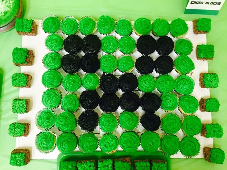 cupcakes are arranged in the shape of shamrocks on a green tablecloth