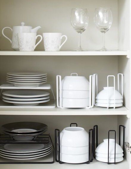 white dishes and glasses are sitting on the shelves