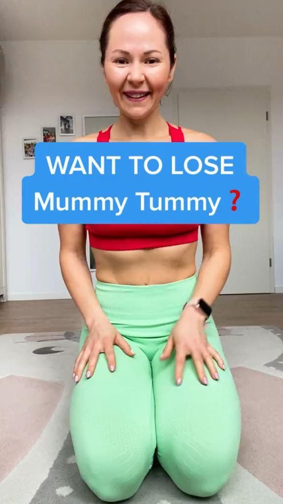 a woman sitting on top of a floor holding a sign that says want to lose mommy tummy?