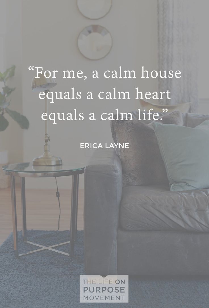 a living room with a couch, table and clock on the wall that says for me, a calm house equals a calm heart equals a calm life?