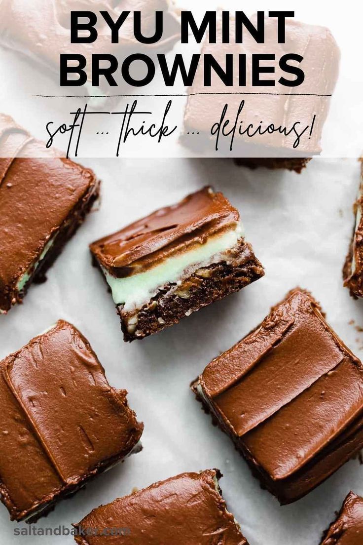 several pieces of chocolate cake sitting on top of a white tablecloth covered in frosting