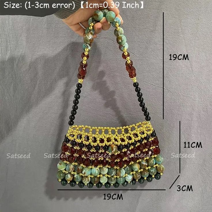 BISA meaning greatly loved symbolizes the care, attention, and affection poured into crafting this bag, as well as the adoration it is meant to receive from its owner. Bisa’s deep rich colors and beautiful gems evoke are effortlessly a cherished possession. Square Beaded Shoulder Bag For Gifts, Beaded Shoulder Bag Gift, Bohemian Rectangular Bag With Colorful Beads, Bohemian Beaded Bag As Gift, Multicolor Beaded Bags For Gifts, Gold Beaded Bags For Daily Use, Gold Beaded Bag For Daily Use, Bohemian Beaded Bags For Gifts, Beaded Pouch Shoulder Bag As Gift