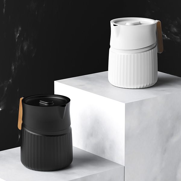 two white and black cups sitting on top of each other