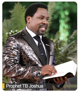 a man in a tuxedo holding a book