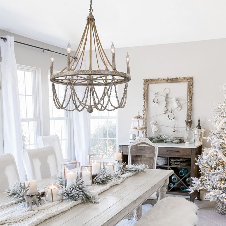 a dining room table decorated for christmas with candles