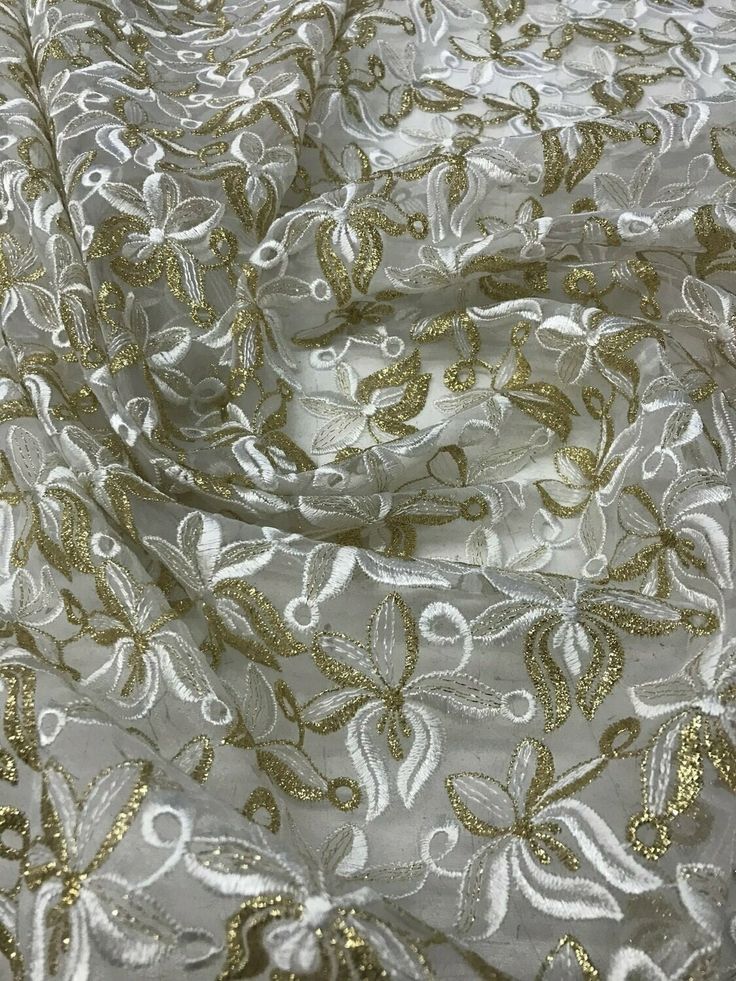 "Content: 100% polyester Organza embroidered lace mix with white and gold This fabric is beautiful and it is perfect for dresses, skit, tops, draping, and more Width: 45/47\" price per yard" Party Cream Embroidered Fabric With Floral Design, Cream Embroidered Fabric With Floral Design For Party, Elegant White Embroidered Fabric For Celebrations, Gold Fitted Floral Embroidered Dupatta, White Lace For Spring Party, Cream Resham Embroidered Fabric For Party, Festive Spring Dupatta With Lace Work, Fitted Gold Dupatta With Floral Embroidery, Gold Dupatta With Floral Embroidery