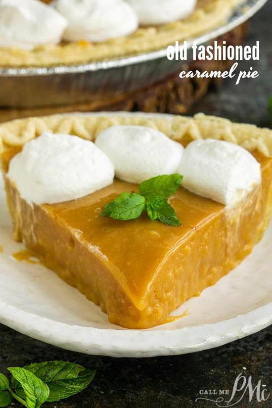 a slice of pumpkin pie topped with whipped cream and mint leaves on a white plate