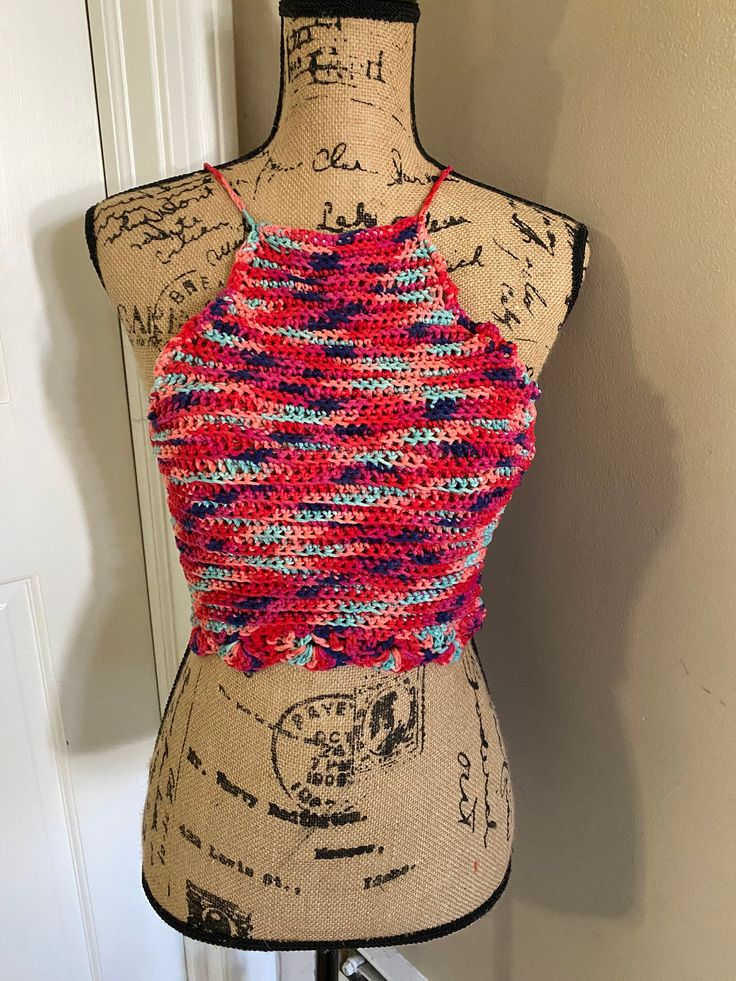 This is a multi-colored crocheted summer top. Handcrafted.  Ties behind the neck and across the back.  Adjustable to fit you. Size: Small Multicolor Halter Neck Top For Beach Season, Multicolor Stretch Halter Top For Spring, Spring Multicolor Stretch Halter Top, Multicolor Stretch Tank Top For The Beach, Multicolor Stretch Summer Tank Top, Summer Multicolor Stretch Tank Top, Multicolor Stretch Crochet Top For Spring, Multicolor Crop Top Halter For Vacation, Multicolor Crop Halter Top For Vacation