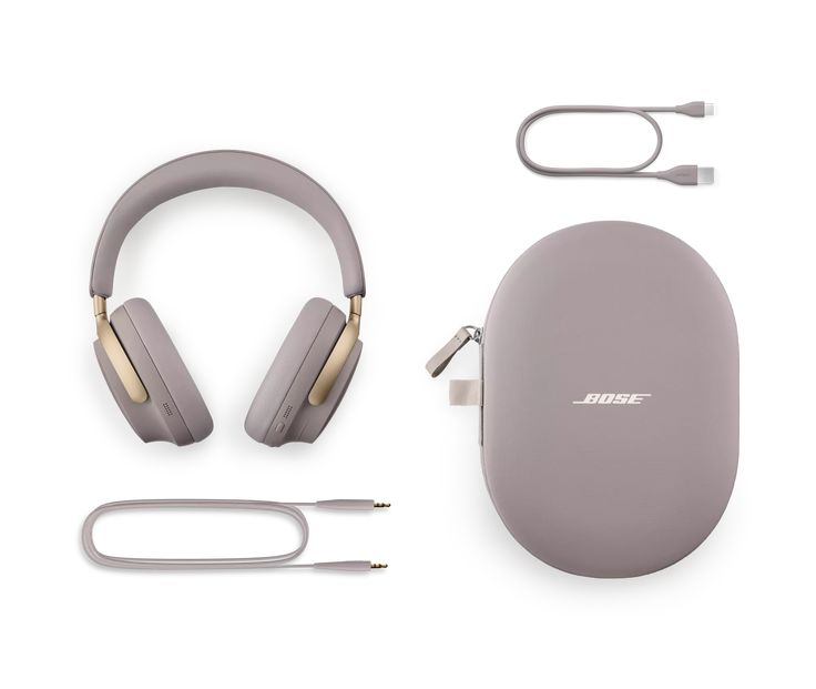 the wireless headphones and accessories are laid out on a white surface, including an earphone