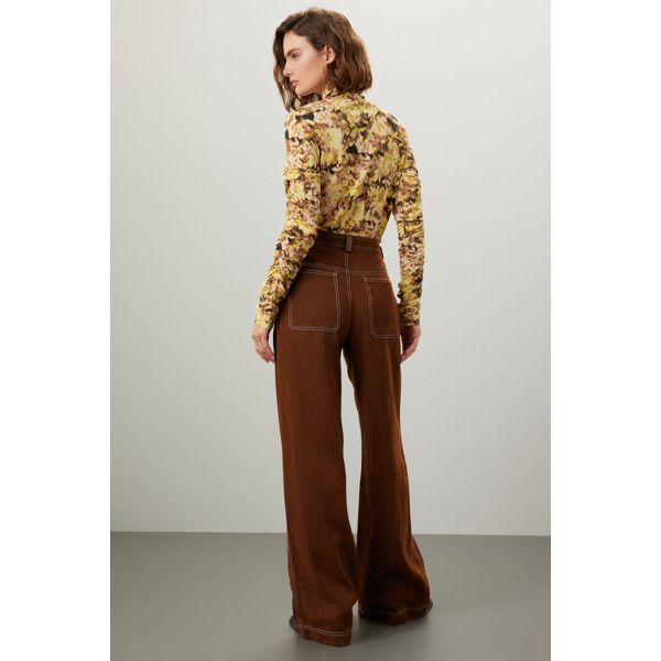 Brown cotton (55% Polyester, 45% VIscose). Pants. Front zipper fly with button closure. 32" inseam. 10" rise. Imported. Retro Wide Leg Pants For Fall, Retro Cotton Bottoms For Fall, Retro Trousers Jeans For Fall, Retro Jeans Shaped As Trousers For Fall, Trendy Wide Leg Pants With Button Closure For Fall, Retro Wide Leg Bottoms For Fall, Cotton Straight Leg Pants With Button Zip Fly, Wide Leg Jeans With Button Closure For Fall, Retro High-waisted Pants For Fall