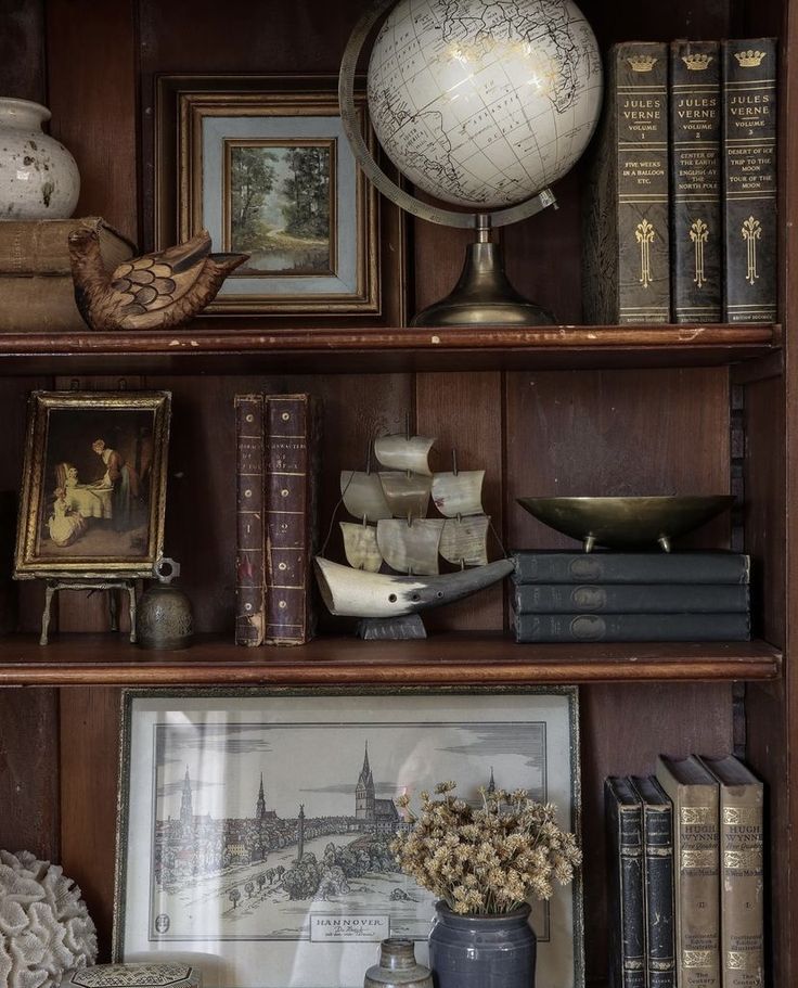 an old book shelf with books, pictures and other items on it's shelves