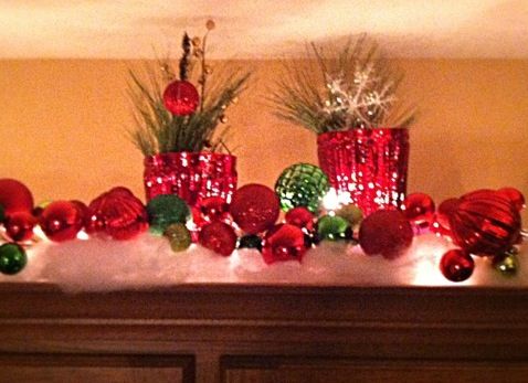 christmas decorations on top of a mantle in a living room