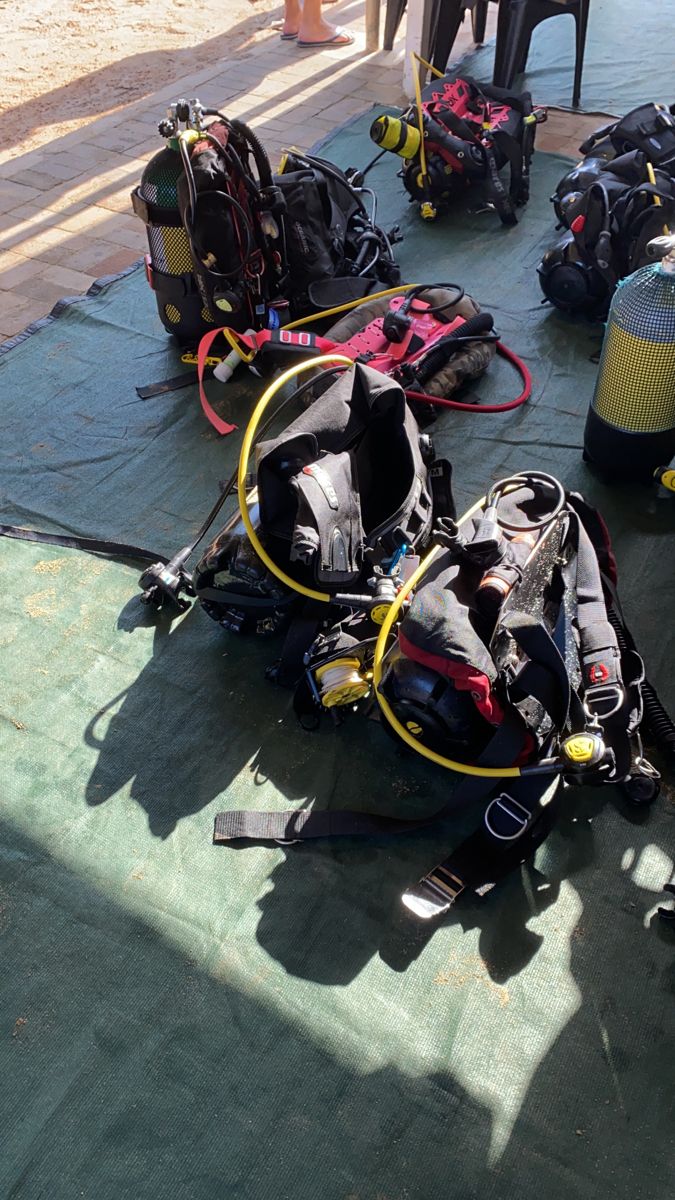 scuba gear and equipment laid out on the ground