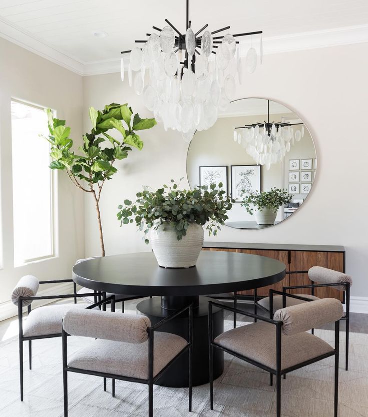 a dining room table with four chairs and a round mirror above it that says, furniture