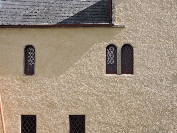 the side of a building with three windows