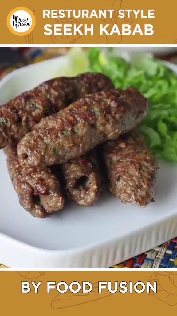 some food is on a white plate with lettuce in the background and an advertisement for restaurant style seekh kabab