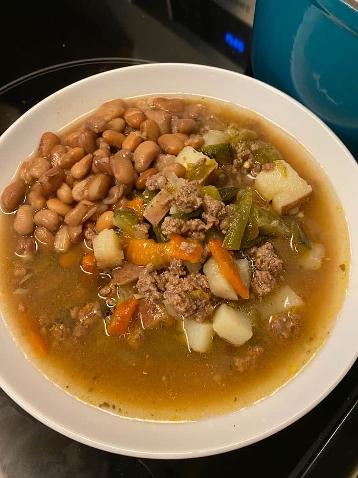 a white bowl filled with soup and beans