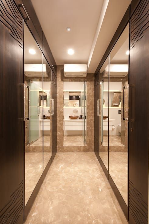 an empty bathroom with glass doors and marble flooring is seen in this image from the inside