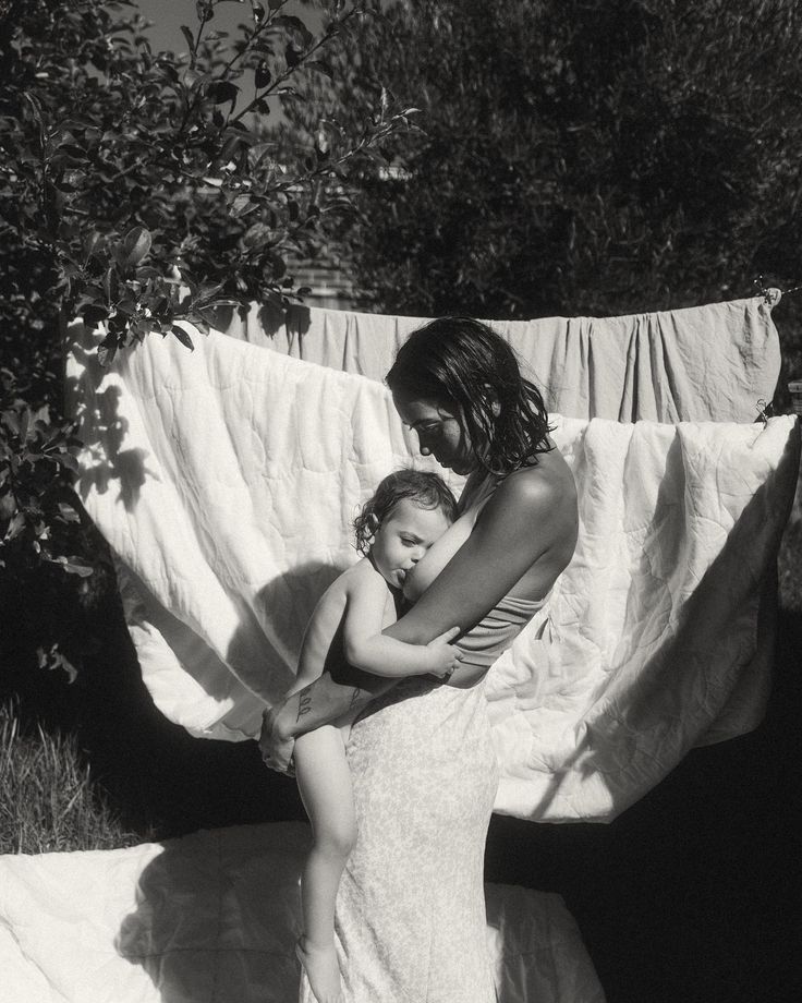 a woman holding a baby in her arms