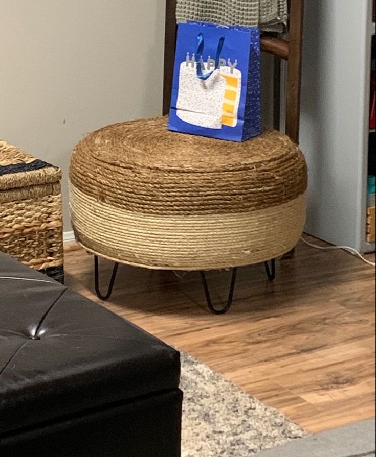 a chair with a bag on top of it in a living room next to a footstool