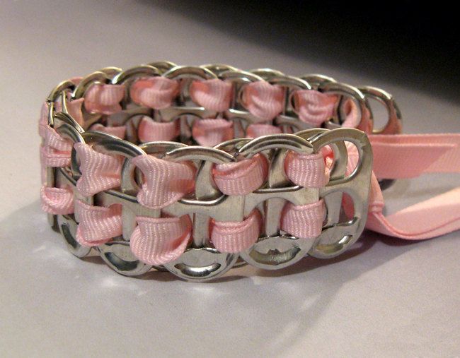 a pink and silver bracelet sitting on top of a table