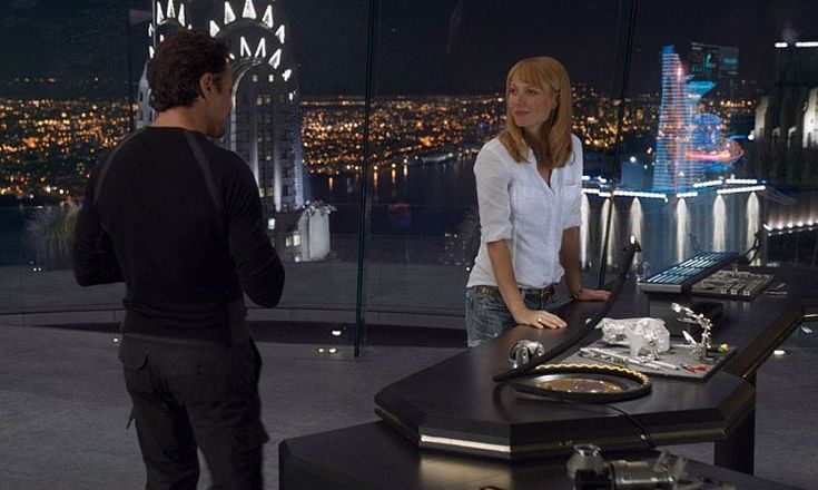 a man and woman standing in front of a dj's turntable on top of a building