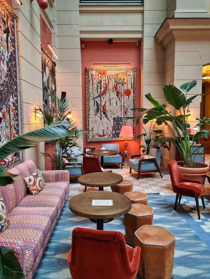 the lobby is filled with colorful furniture and plants