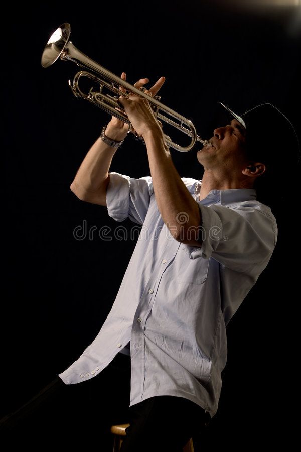 a man in white shirt playing a trumpet on stage royalty images and clippings