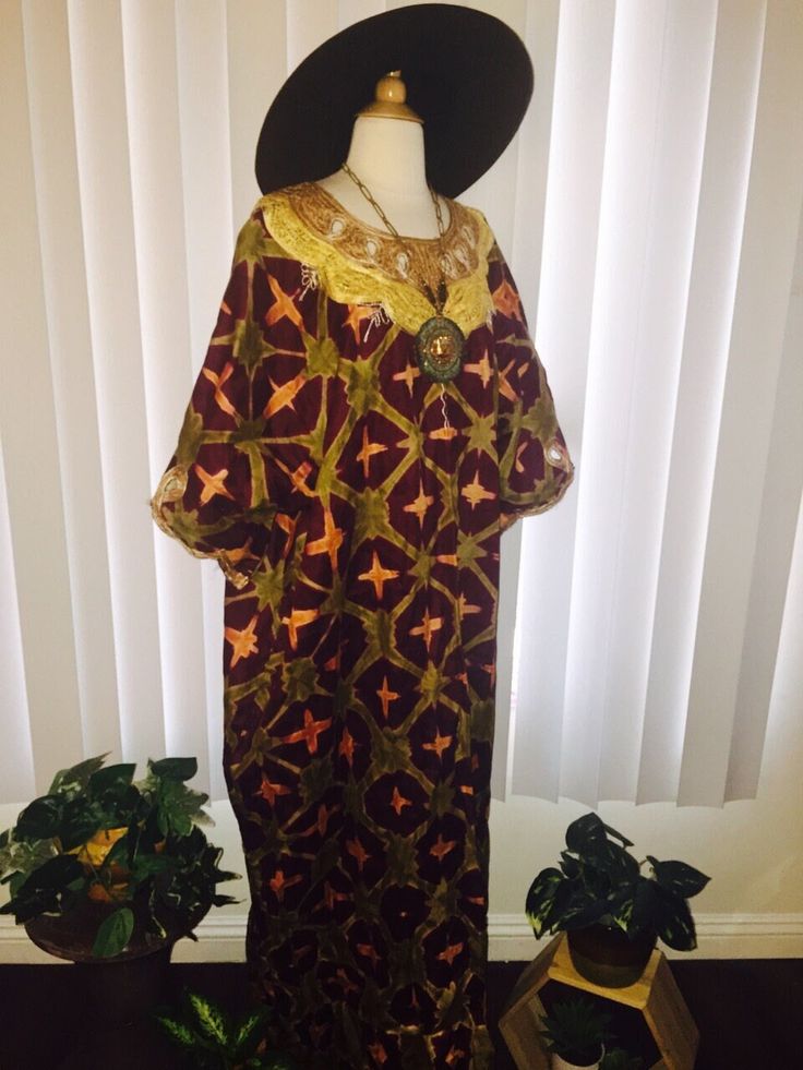 This is a stunning  kaftan dress done in brown with a beautiful ethnic print. It has short sleeves which are trimmed in an embroidered crochet like texture. This same texture can be found around the neckline making this dress simply amazing. I believe this dress to be oversized and to have a very african / tribal look. It slips on overhead and has a very loose fit and maxi length.  Era: 1970's Label: None Fabric:  Cotton blend Condition: Good Size : I believe one size fits all but see measuremen Traditional Brown Embroidered Dress, Traditional Long Brown Dress, Traditional Brown Kaftan For Festival, Long Brown Festival Kaftan, Traditional Short Sleeve Batik Print Kaftan, Traditional Short Sleeve Kaftan With Batik Print, Bohemian Brown Dress With Batik Print, Bohemian Embroidered Short Sleeve Thobe, Bohemian Short Sleeve Embroidered Thobe