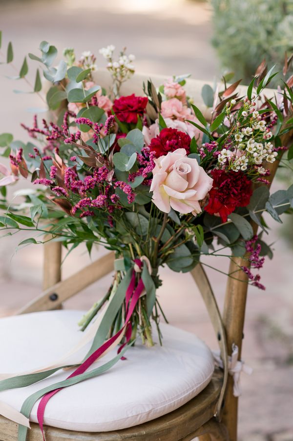 a bunch of flowers sitting on top of a chair