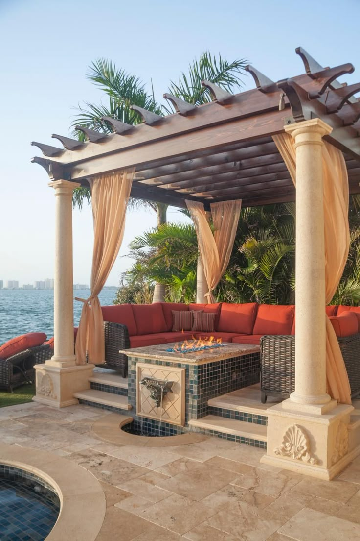 an outdoor living area with fire pit and gazebo