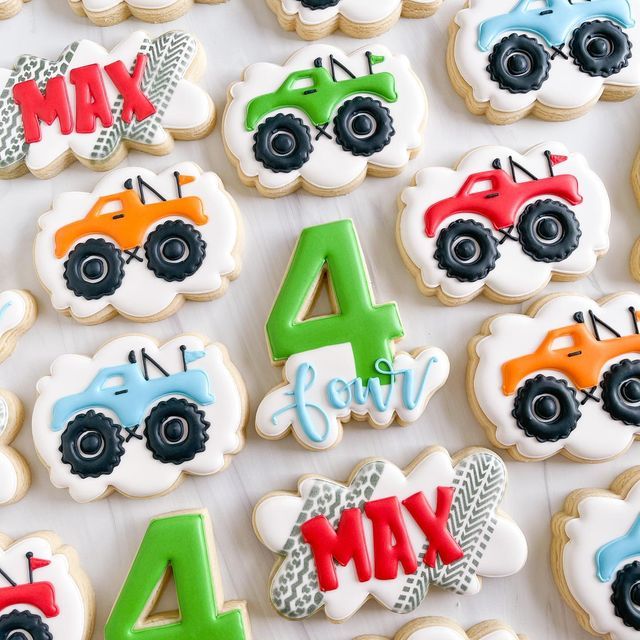 decorated cookies are arranged in the shape of cars and trucks, along with numbers for each cookie