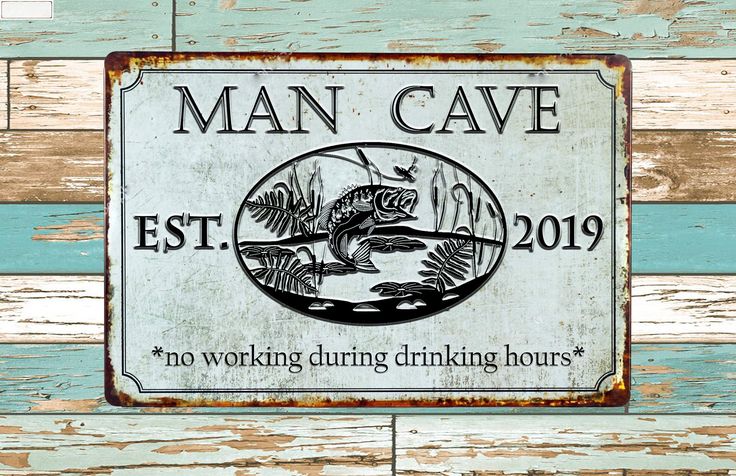 a man cave sign mounted to the side of a wooden wall