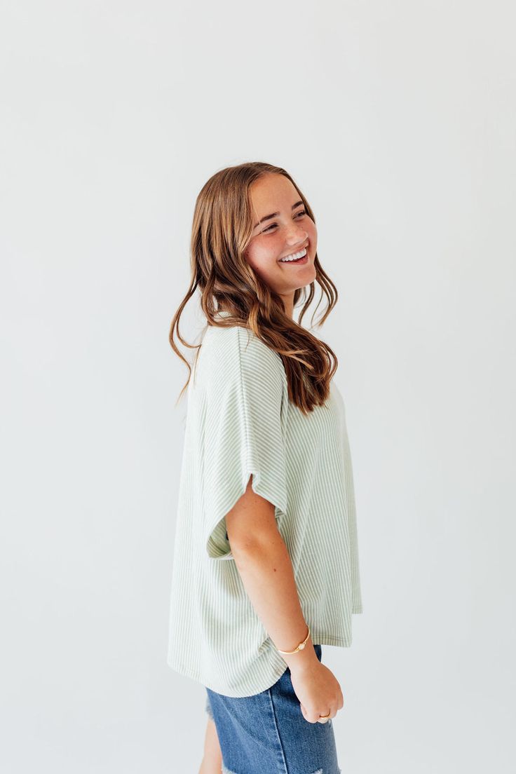 Experience comfort and style with the Journee Top. Its light green color with white stripes adds a touch of freshness, while the dolman sleeves and straight hem provide a relaxed fit. Perfect for any casual outing or lounging at home. Elevate your wardrobe with this versatile and chic top! Fits true to size. Model is wearing a small and is 5'3". Plus model is wearing a 1X and is 5'8". Size Chart Length Bust S 22" 48" M 22" 50" L 23" 48" 1x 24" 52" 2x 24" 54" 3x 25" 56" *All measurements are appr Green Short Sleeve Tops For Lounging, Comfy Tops For Spring Lounging, Relaxed Striped Tops For Spring, Comfy Tops For Lounging In Spring, Green Ribbed Top For Loungewear, Comfy Lounging Tops For Spring, Comfy Spring Lounging Tops, Short Sleeve Tops For Spring Lounging, Green Ribbed Relaxed Fit Tops