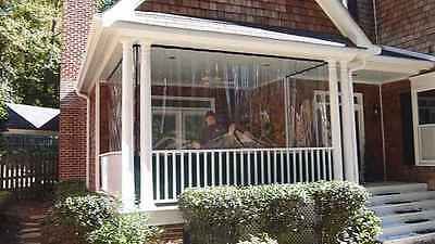 two people sitting in the window of a house