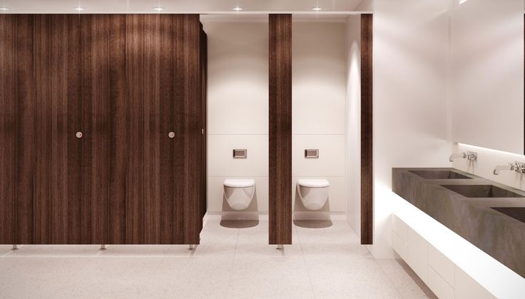 a bathroom with two urinals next to each other in front of wooden doors