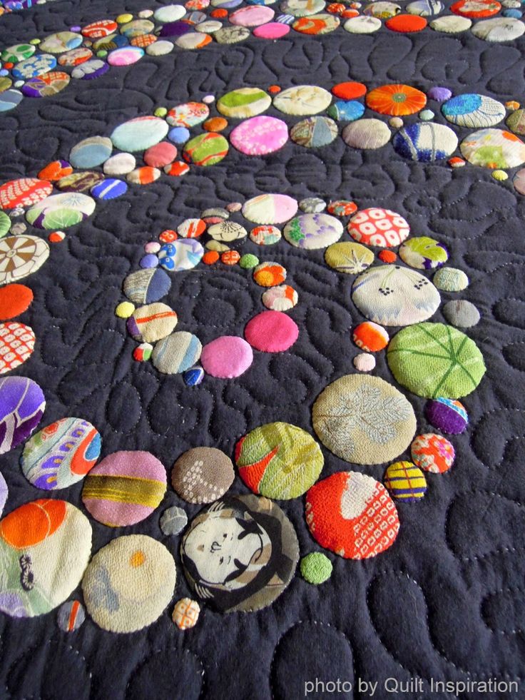 a quilted table top with many different colored buttons on it