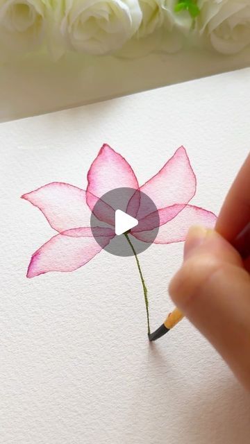 someone is drawing a pink flower with a pencil