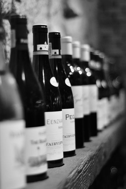 bottles of wine are lined up on a shelf