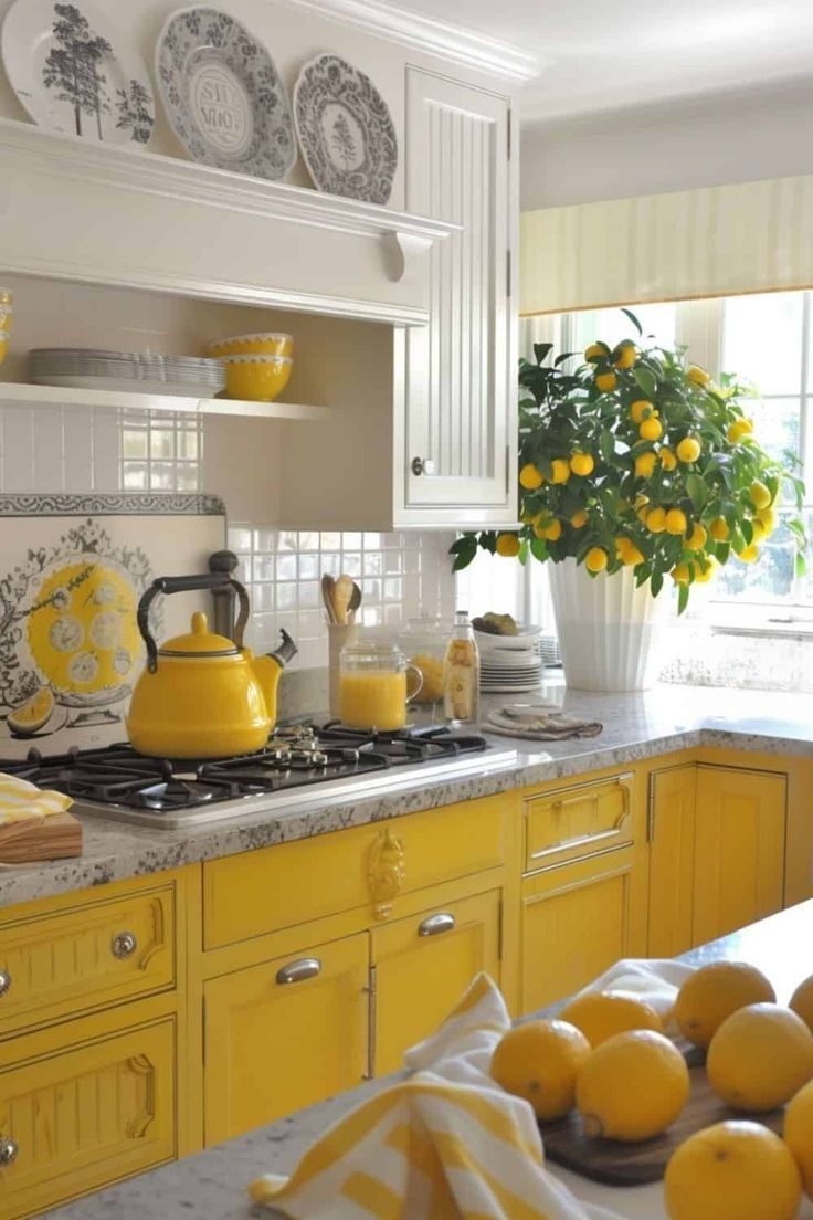 a yellow kitchen with lemons on the counter and plates in front of it,