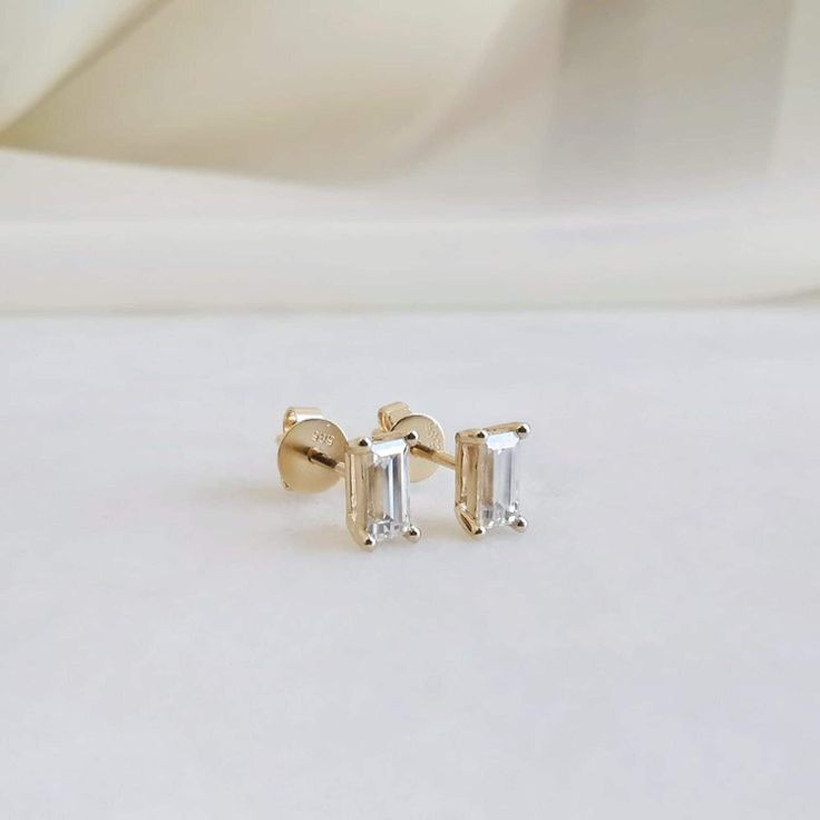 1.0 Ctw Moissanite Stud Earrings, Solitaire Emerald Moissanite Stud Earrings, Emerald Cut Earrings, Minimalist Earrings, Handmade Jewelry, Anniversary Gifts For Her, Push Back Emerald Cut Earrings, Custom Wedding Gifts ● Product Details: Materials : Silver, 10K Gold, 14K Gold, 18K Gold Gemstone: Moissanite Diamond Shape: Emerald Cut Diamond Carat: 1.0 CTW Measurement: 6x4 MM Each Color: Colorless Clarity: VVS Luster: Excellent Make: High Quality (Made To Order) (1-2 Week Dispatch) ● Metal Option: 925 Sterling Silver 10KT/14KT/18KT Gold Metal tone can be done in Yellow, White & Rose ● Product Description: Indulge in elegance with our Round Cut Solitaire Stud Earrings crafted from 10K and 14K yellow gold. Each dazzling stud features a brilliant-cut diamond, radiating timeless sophistication. Emerald Cut Earrings, Wedding Earring, Earrings Emerald, Cut Earrings, Emerald Cut Moissanite, Solitaire Studs, Custom Wedding Gifts, Moissanite Earrings, Custom Pendants