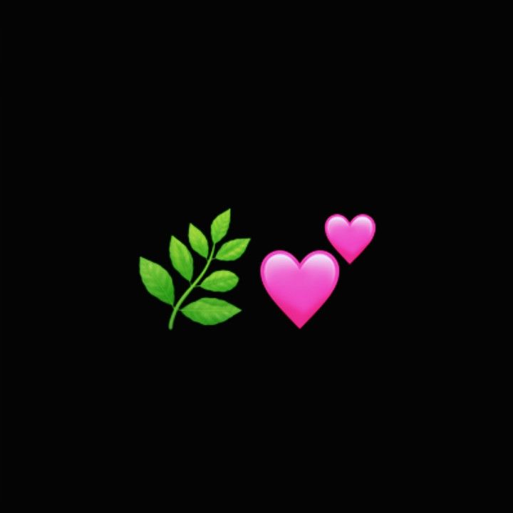 two pink hearts and a green leaf on a black background