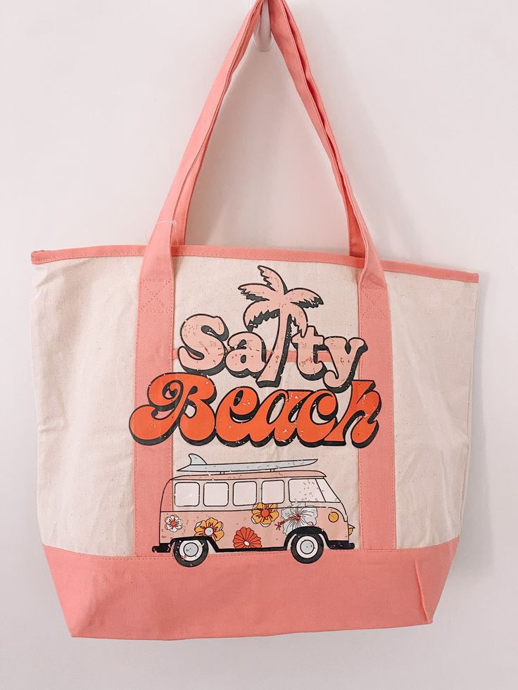 a pink and white tote bag with the words salty beach printed on it's front