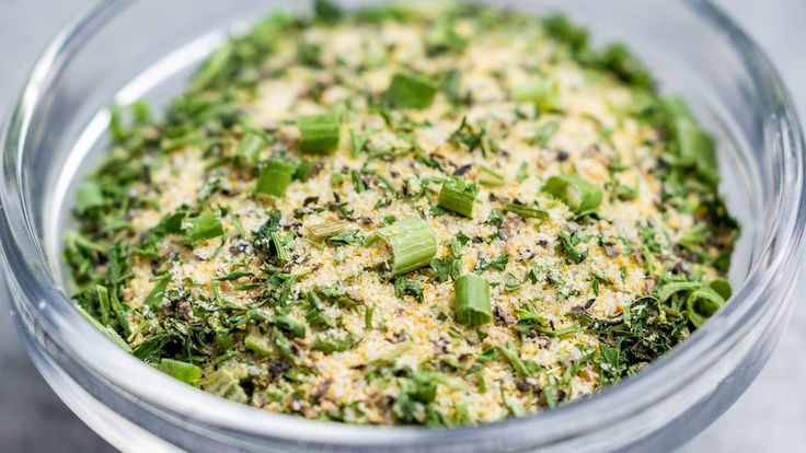 a glass bowl filled with broccoli florets and seasoning