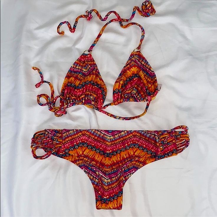 Never Worn! It’s Such A Cute, Beachy Print Bikini, With Soft Luxurious Fabric Both Pieces Are A Size Small! Orange Triangle Top Swimwear For Beach, Red Triangle Top Swimwear For Vacation, Orange Beachy Swimwear With Tie-side Bottom, Orange Tie-side Bottom Swimwear For Beach, Orange Tie-side Beachy Swimwear, Orange Tie-side Bottom Swimwear, Vibrant Triangle Top Swimwear For Poolside, Beachy Triangle Top Swimwear For Sunbathing, Multicolor Halter Neck Swimwear For Summer