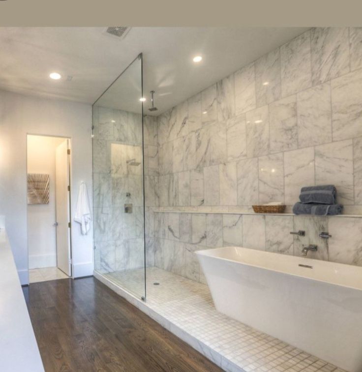 a large bathroom with marble walls and floors