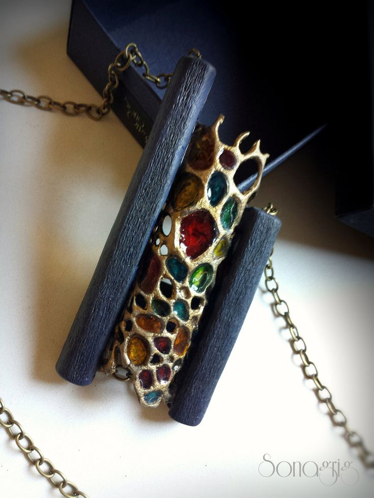 the necklace is made from wood and has multicolored stones