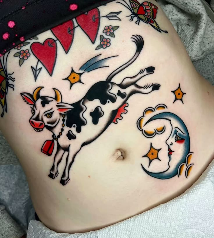 a woman's stomach with tattoos on it and an image of a cow in the middle