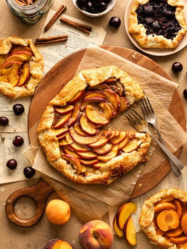 there is a pie on the table with fruit around it